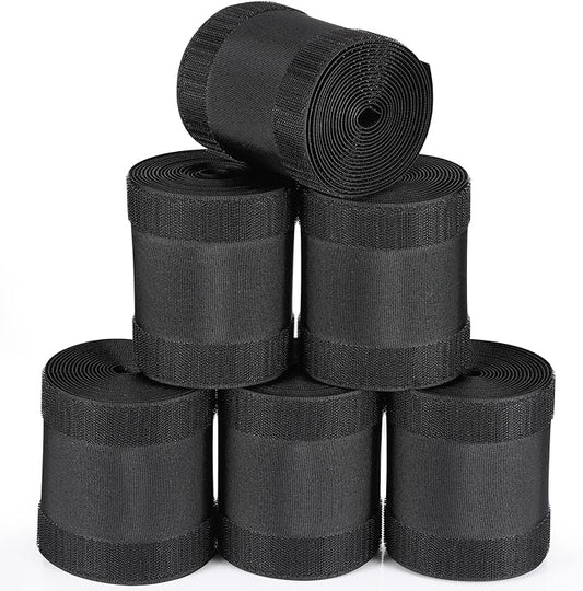 6 black carpet cord cover rolls stacked together on white background